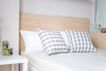 Fototapeta na wymiar Luxury pillows on white bed in bedroom