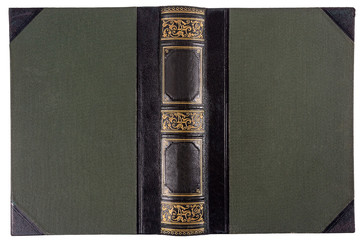 Old opened book's cover isolated on white. Textile binding with leather accents and gold embossed pattern.