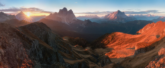 Obraz premium View of famous Dolomites mountain peaks glowing in beautiful golden morning light at sunrise in summer, South Tyrol,Italy Monte Pelmo and Monte Civetta in sunny day. Famous best alpine place