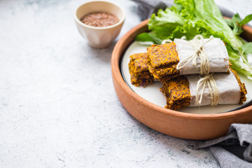 Crunchy crispy breads or flax seeds flatbreads. Vegan food. Copy space. Green salad leaves