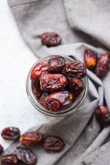 Date fruites, dates or sweet Iranian hurma in glass jar. Natural organic dieting dessert food. Vegan meal.