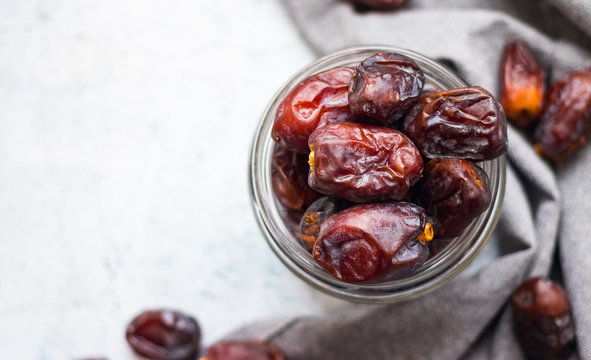 Date fruites, dates or sweet Iranian hurma in glass jar. Natural organic dieting dessert food. Vegan meal. Copy space. Top above view