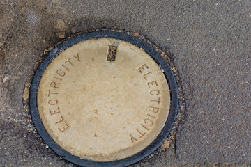 Old utility manhole in street.