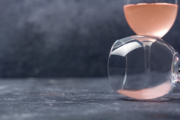 Two glasses with rose wine on a dark background. Half empty glass lies on its side. Wine tasting. Drunkenness concept. Close up, copy space, law key