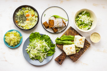 Cabbage vegetable food. Lunch with soup, stew, wrap bread rolls and fresh detox dieting salad. Vegan meal.
