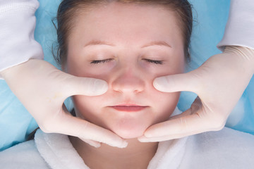 close-up, cosmetology, doctor doing facial massage to improve blood circulation