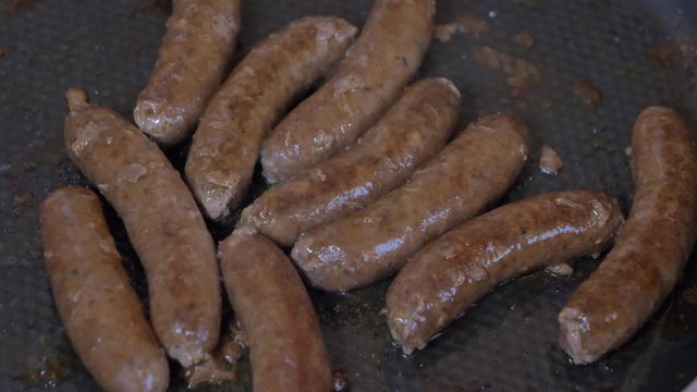 Close up shot of sausages and on the grill - Grilling sausages, cooking. Grilling food, bbq, barbecue, 4k