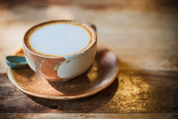 Hot coffee in shop with sun light