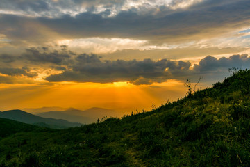 Beautiful landscape. Bright colorful sunset opening from the top of the mountain in the summer. Storm clouds during sunset. relax