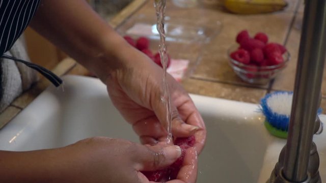 woman Washing Rasberries in slow motion