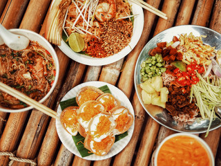 A variety of food resting on a bamboo table.