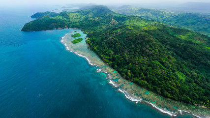 Fototapeta na wymiar Wide aerial shot of Panama coastline landscape with island, coral and clear sea with turquoise water. Drone photo. Top view.