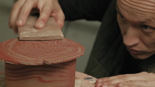 Ceramist work in the workshop.