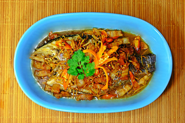 Steamed whole Tilapia fish with soy sauce, pork belly and ginger.