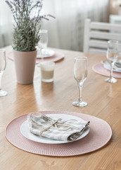  Empty plate and silverware set on wooden table