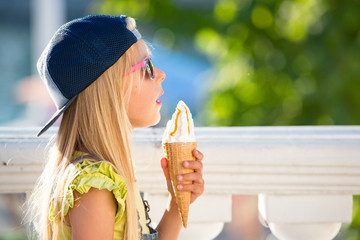 Kid eating ice cream outdoors