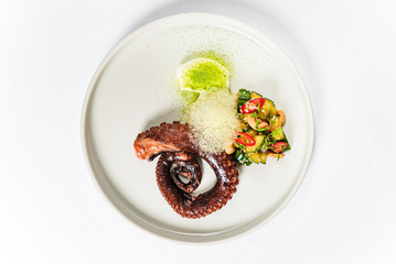 Slate of appetizing boiled octopus with vegetable garnish