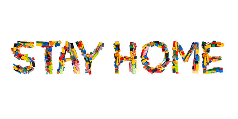 Inscription Stay Home of the English alphabet  from multi-colored children's plastic constructor on a white isolated background.Child and medical  pattern.Sign  from a photo of kids design