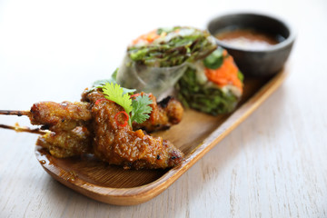 Chicken Satay on wood background