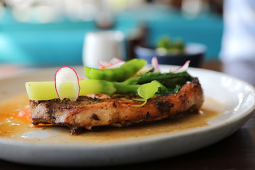 Grilled Porkchop and vegetables on top on wood background