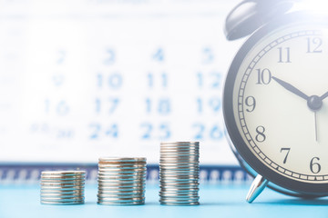 alarm clock calendar coins, selective focus, toned image, and the flare in the upper right corner,...
