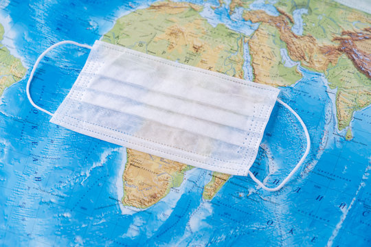 medical mask on the world map, selective focus, the concept of a worldwide pandemic
