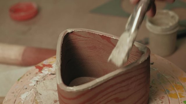 Ceramist work in the workshop.