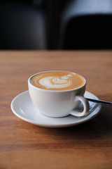 cappuccino or Latte art coffee made from milk on the wood table in coffee shop