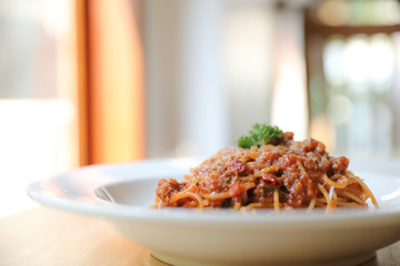spaghetti Bolognese with minced beef and tomato sauce garnished with parmesan cheese and basil ,...