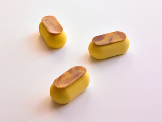 three banana desserts with chocolate on a white background