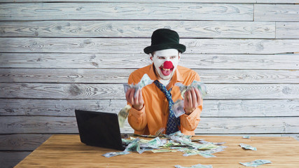 clown businessman with money in his hand. Concept on big boss with money.