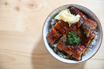 Japanese food unagi don , grilled eel on japanese rice on wood background