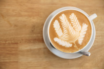 cappuccino or Latte art coffee made from milk on the wood table in coffee shop