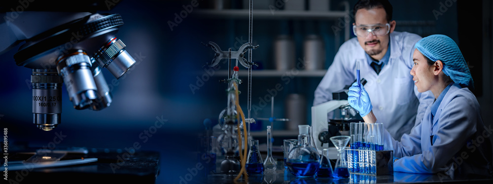 Wall mural banner background of scientist working in laboratory with test-tube and microscope
