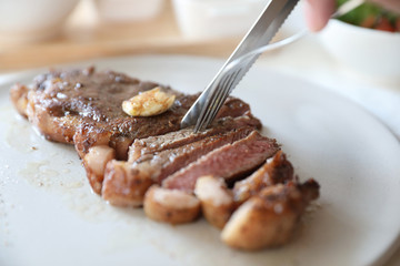 beef steak with salad on white table