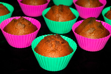 Chocolate cupcakes with a delicious crust on a black background closeup