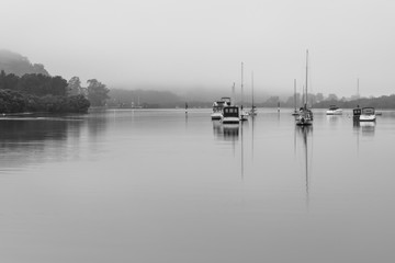 Fototapeta na wymiar Boats on the Bay - Rainy days at the Waterfront in Black and White