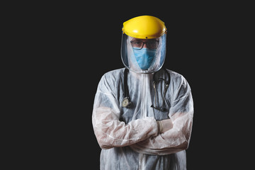 Medical doctor, nurse, surgeon, psychologist working with protective mask, glasses and gloves helping people in the days of panic, pandemic - studio shot on black background.