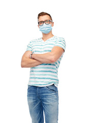 health, quarantine and pandemic concept - young man wearing protective medical mask for protection...