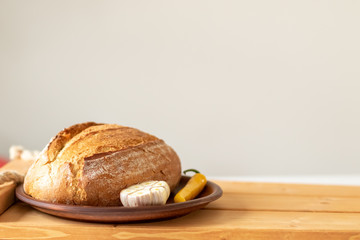 bread. loaf of bread and garlic. bread lies on a wooden table. Copy space. close up