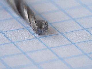 macro drill, on a piece of paper in a cage