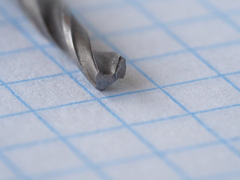 macro drill, on a piece of paper in a cage