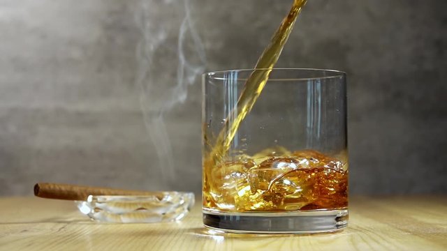 Jet of Whiskey in Highball and Cigar Smoke. Slow Motion
