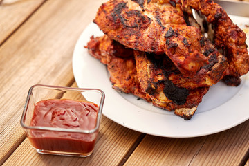 cooking, culinary and food concept - close up of grilled barbecue meat stack on plate