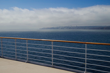 Fog bank or low hanging clouds over land or coastline seen from cruiseship or cruise ship liner on...