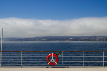 Fog bank or low hanging clouds over land or coastline seen from cruiseship or cruise ship liner on...