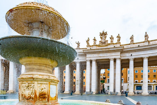 Rome, Italy. The second of four water fountains south of St. Peters Square, Vatican City, near the Basilica, by Gian Lorenzo Bernini, commissioned by Pope Clement X. Colonnades with statues of saints.