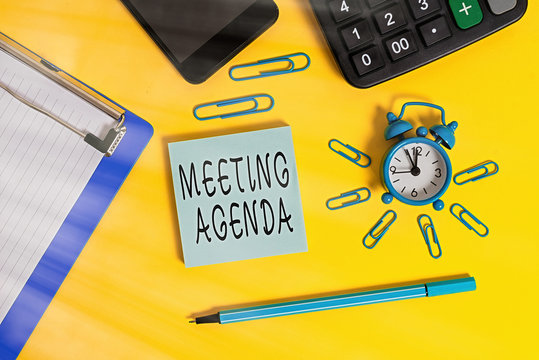 Handwriting text Meeting Agenda. Conceptual photo items that participants hope to accomplish at a meeting Alarm clipboard clips smartphone marker calculator notepad color background