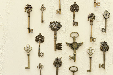 Image of old antique keys over wooden background. Top view, flat lay