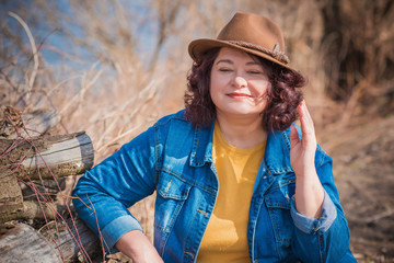 Beautiful mature woman on a walking. A nice middle aged plus size woman standing on the street....